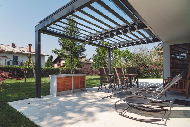 Pergola With Two Lounge Chairs, A Dining Table & Four Chairs And A Storage Cupboard